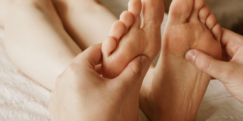 A closeup shot of masseur massaging a female's feet